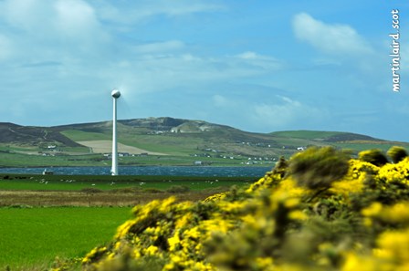 a wind turbine in Orkney set within the rural landscape