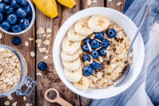 bowl of muesli type cereals with banana and blueberries