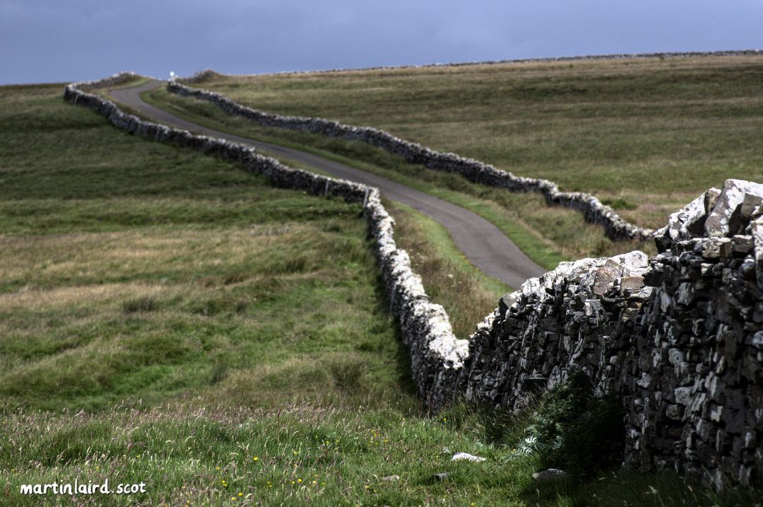 a single track road which runs round Rousay with stone walls on each side