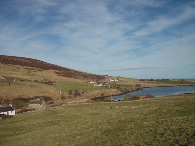 a sweep over the landscape with the bay edging in and fields and low hills