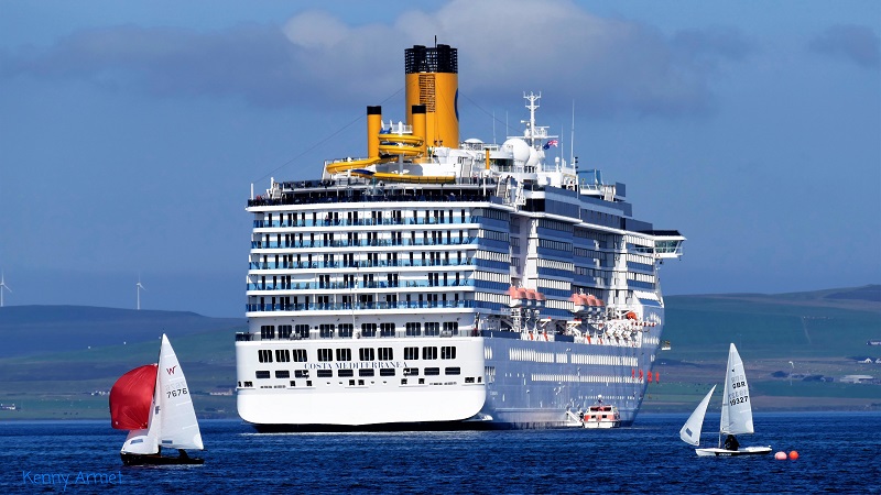 an enormous cruise ship in Kirkwall harbour with 2 tiny yachts in comparison at the regatta