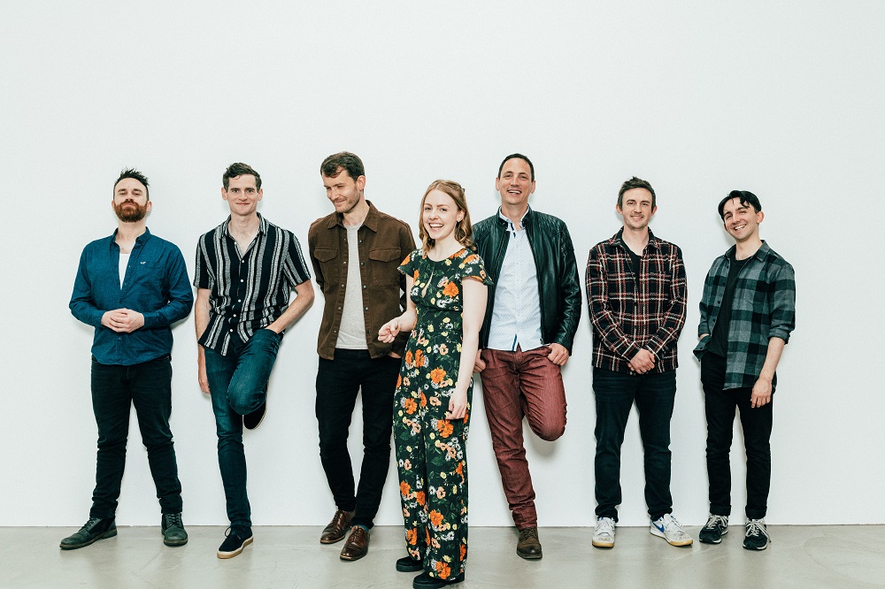 the seven members of Manran, thesix men at the back with the woman in the front