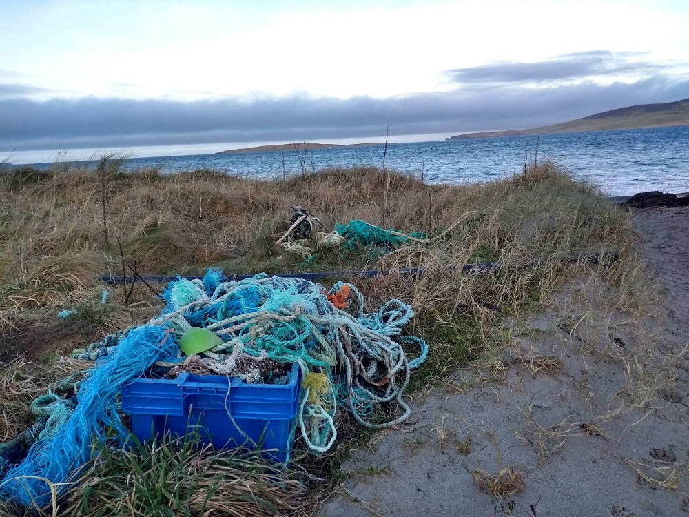 rope and plastic gathered at Evie Sands on a beach clean at the side of sand dunes