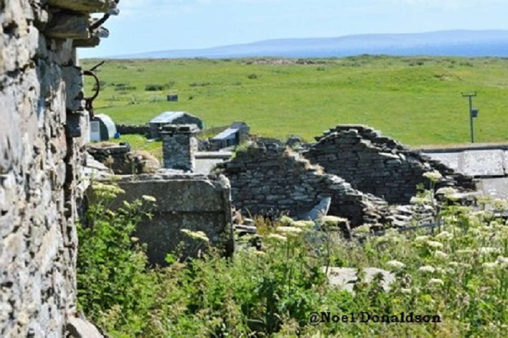 A view over ruined old farm buildings in Westray