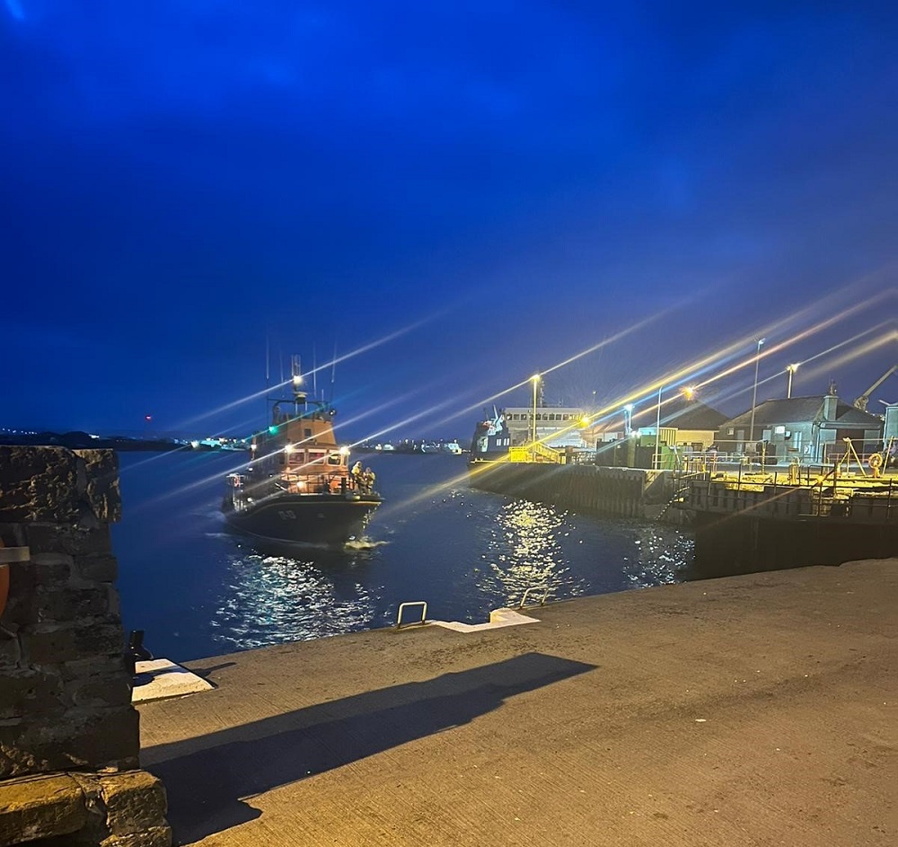 a night time scene of Kirkwall lifeboat coming back into the harbour at Kirkwall