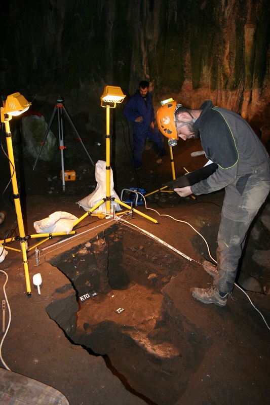 A researcher studies the remains in an excavated site