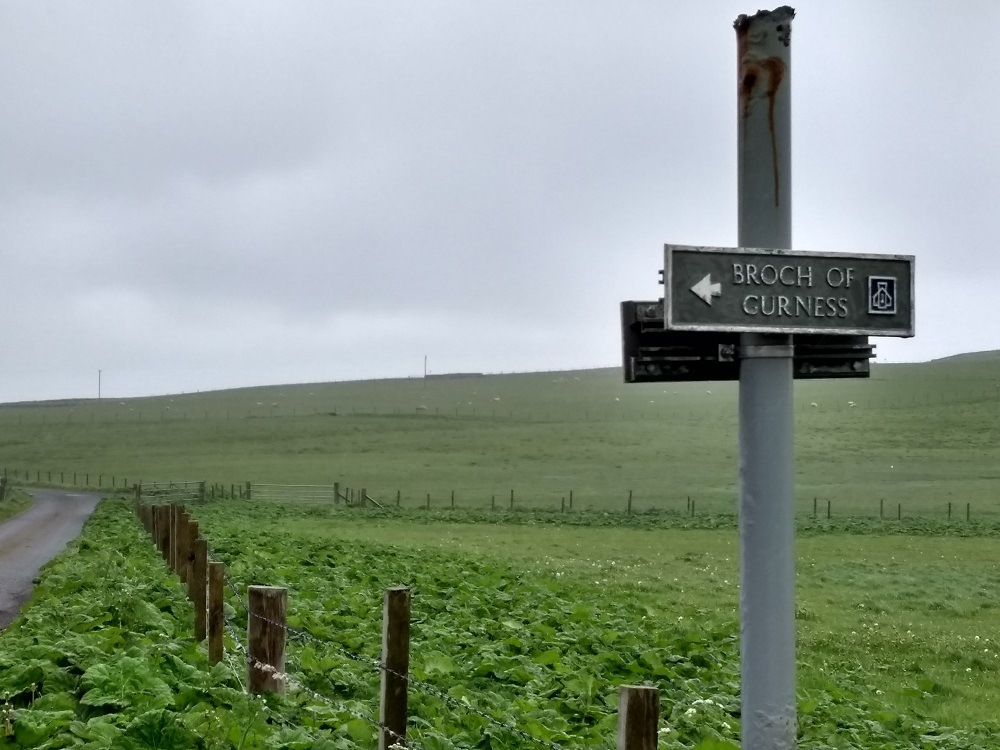 sign post to the Broch of Gurness with the road stretching from it