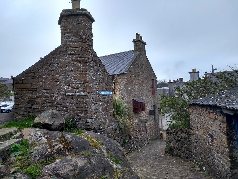 one of the narrow streets in Stromness with a cobbled roadway