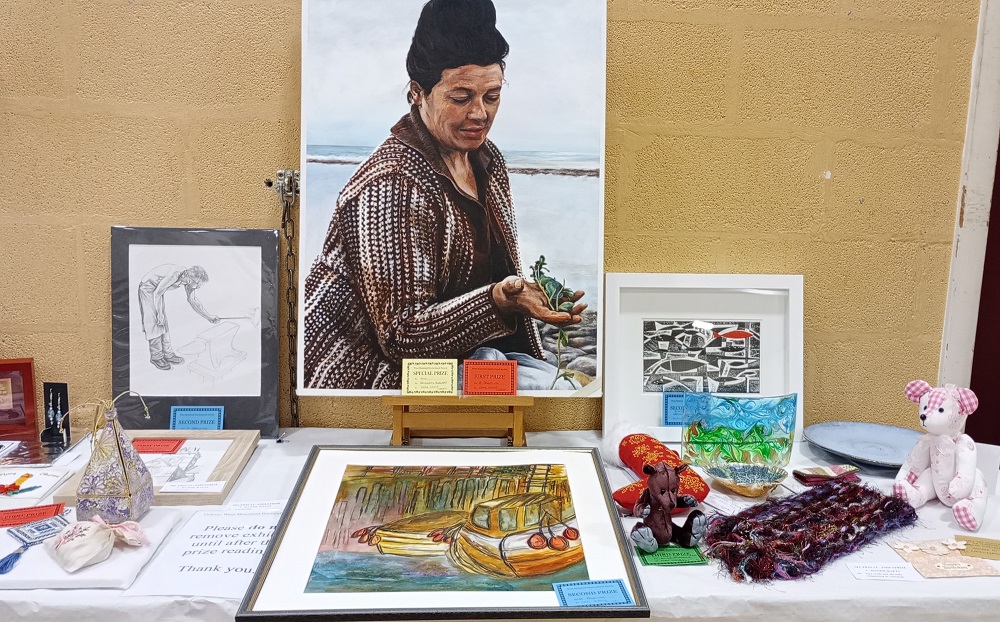 a selection of prize winners in one section of the West Mainland Horticultural and Industrial Show with the winning entry of Painting of Bessie Skea by Emma Grieve.