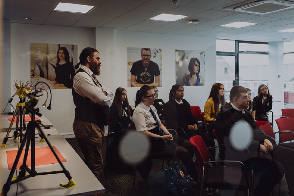 school students and teachers watching the presentation