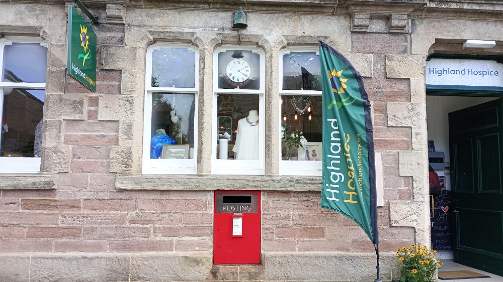 A post box set into the wall to the Highland Hospice shop one the old Post Office in Beauly
