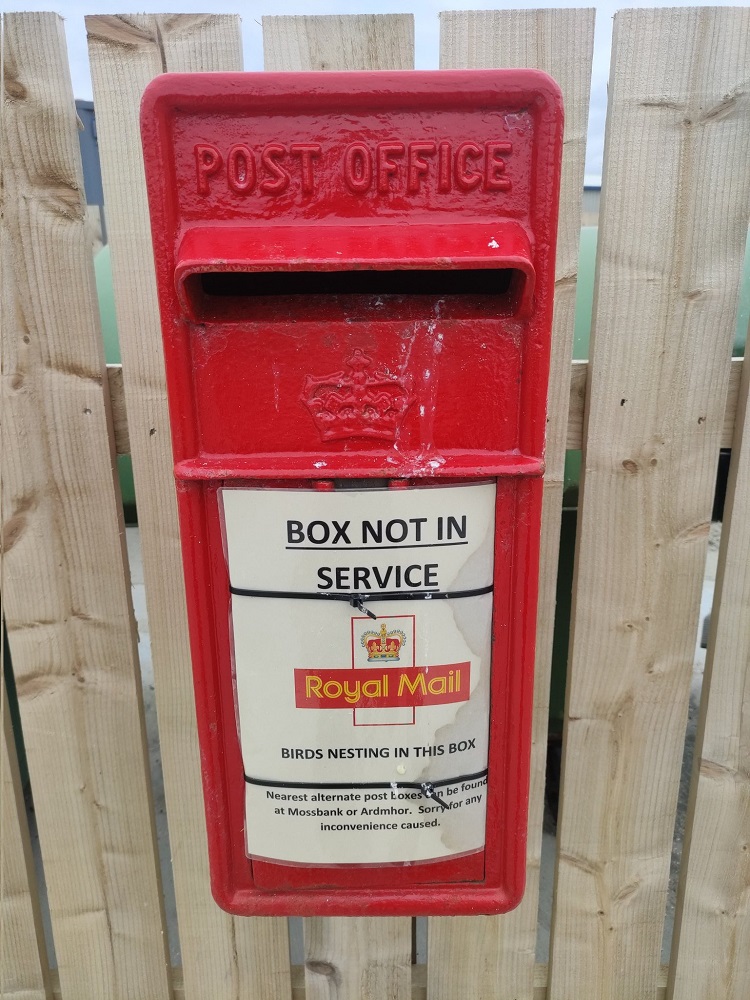 Post box in fend with notice not in service due to birds nesting
