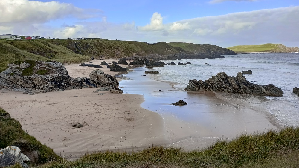 The cliffs and down below the sands of the beach