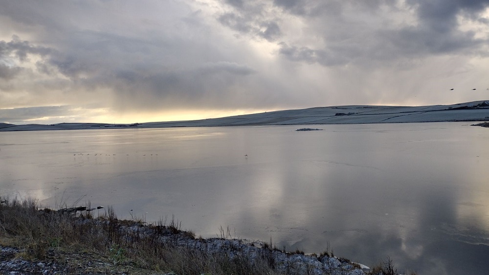 Stenness loch partially frozen on a cold and still December day