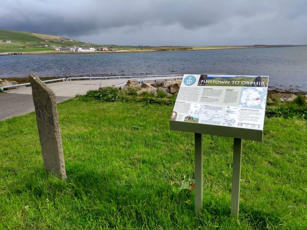 display board and standing stone marker over looking the Bay at Finstown with information about the St Magnus Way Finstown to Orphir