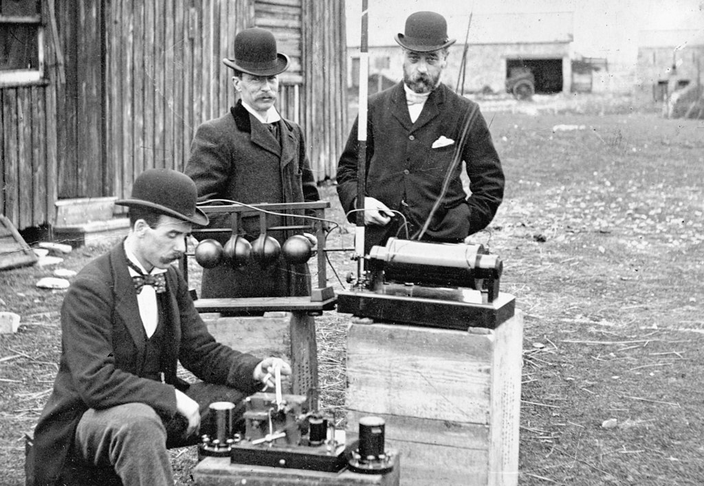 three post office engineers examine Marconi's apparatus