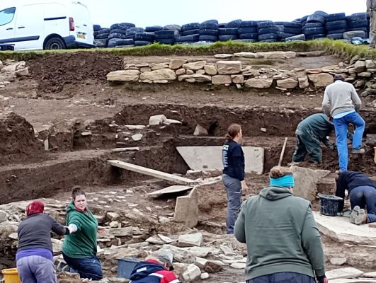 Layers of walls as archaeologists work to uncover the floors and walls of buildings