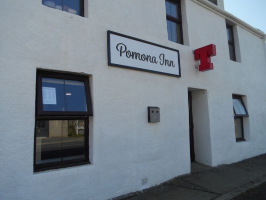 The front of the Pomona Inn with a clean frontage and a large T sign on the outside
