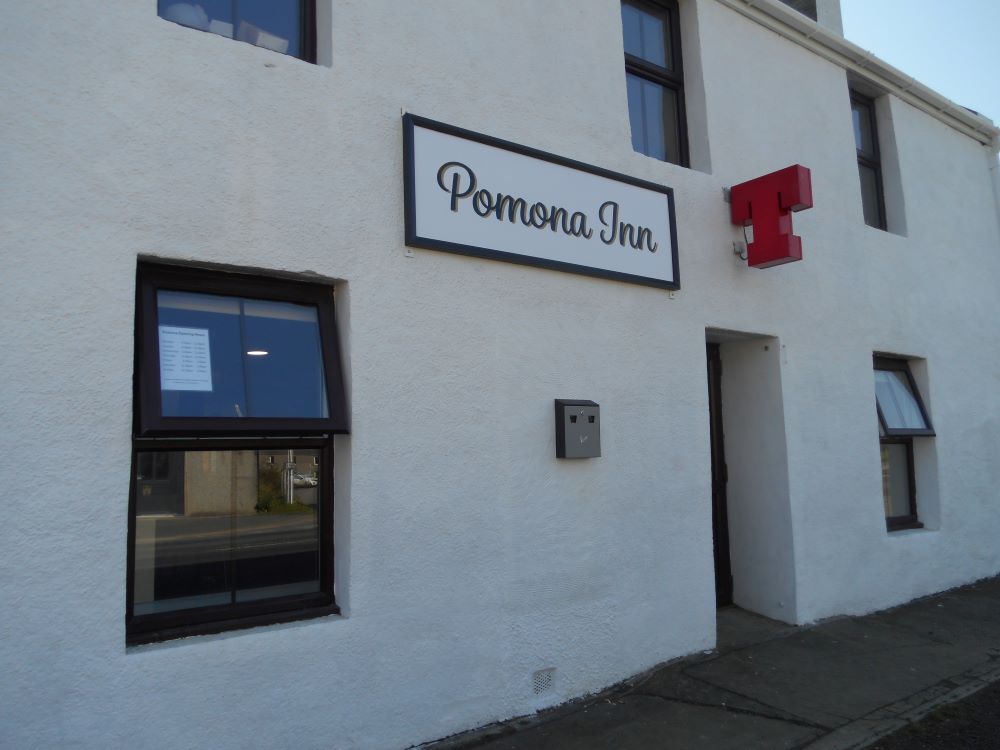 The front of the Pomona Inn with a clean frontage and a large T sign on the outside