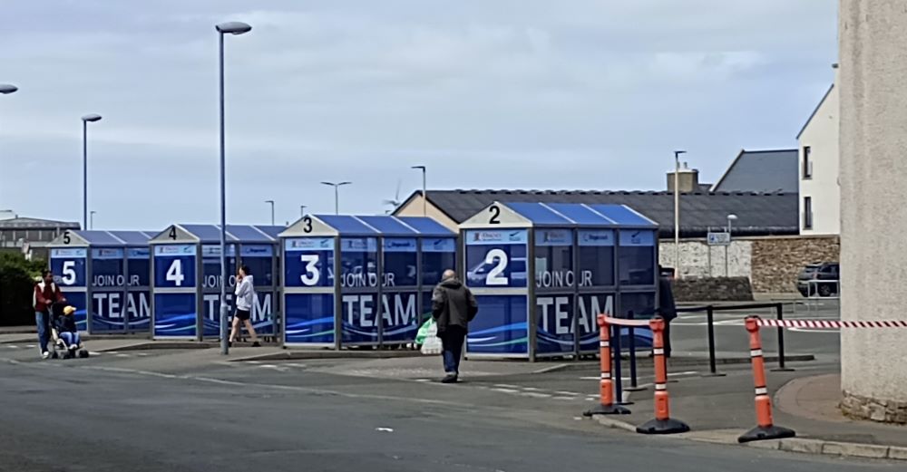 Kirkwall bus station with bus shelters and slogan 'join our team'