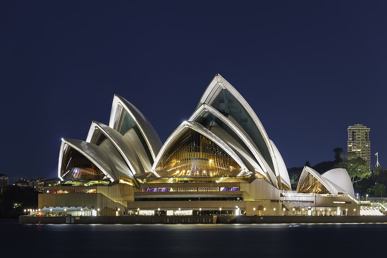 Sydney opera house at night with the iconic shell shaped roof