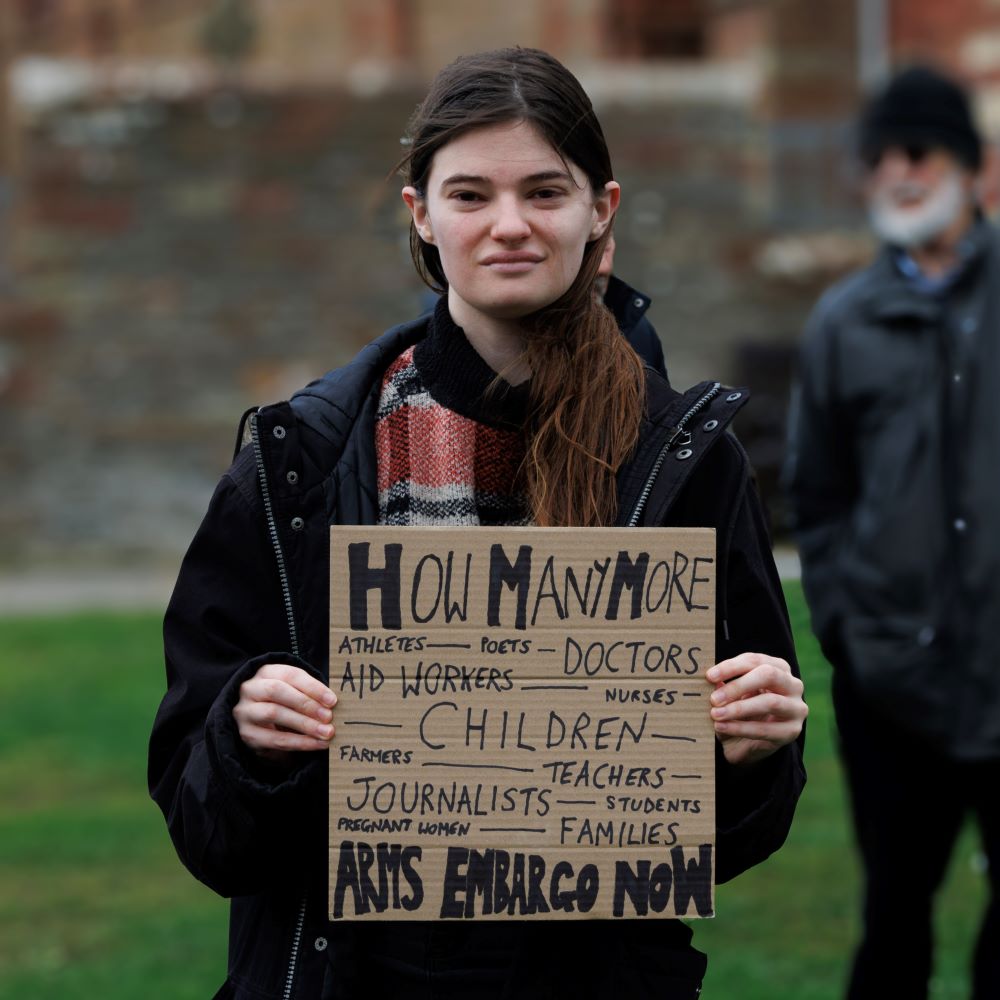 young woman holding poster
