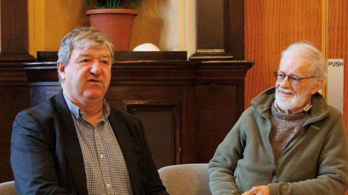 On the left Alistair Carmichael and on the right the chair of the meeting