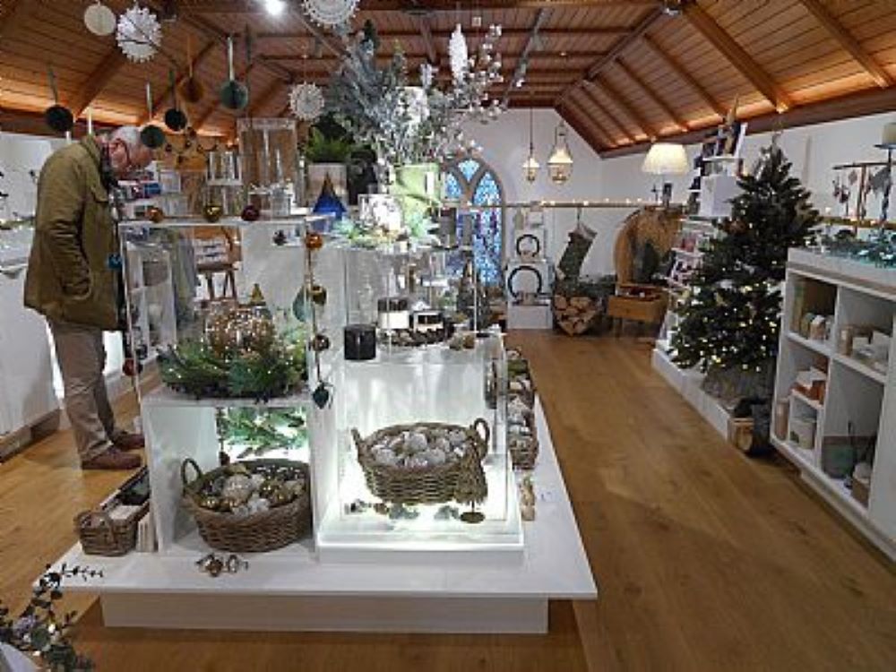 lots of shelves filled with products and a Christmas tree