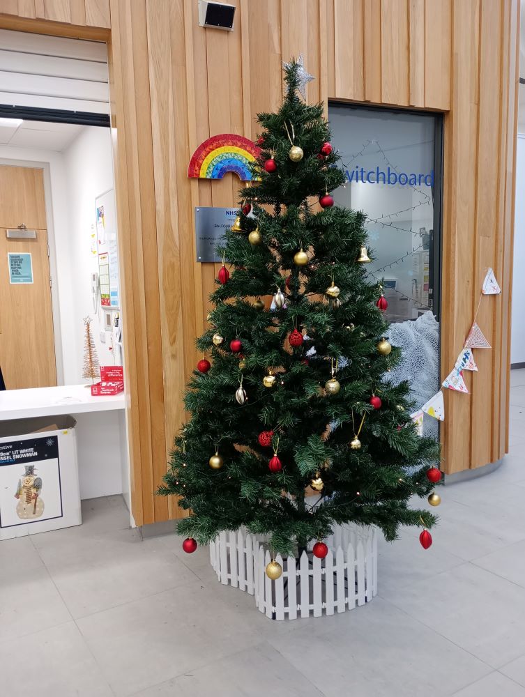 the Christmas tree at the reception point in NHS Balfour Hospital. Traditional decorated tree with star on top