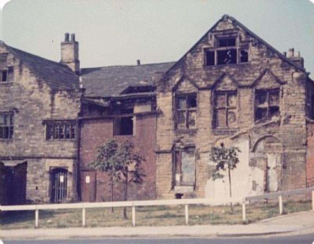 The Old Paper Hall looking up at the windows some are boarded up others open to the elements