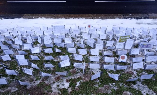 the names of many of those who have been killed in Gaza memorialised on small flags planted into the snow covered Kirk Green