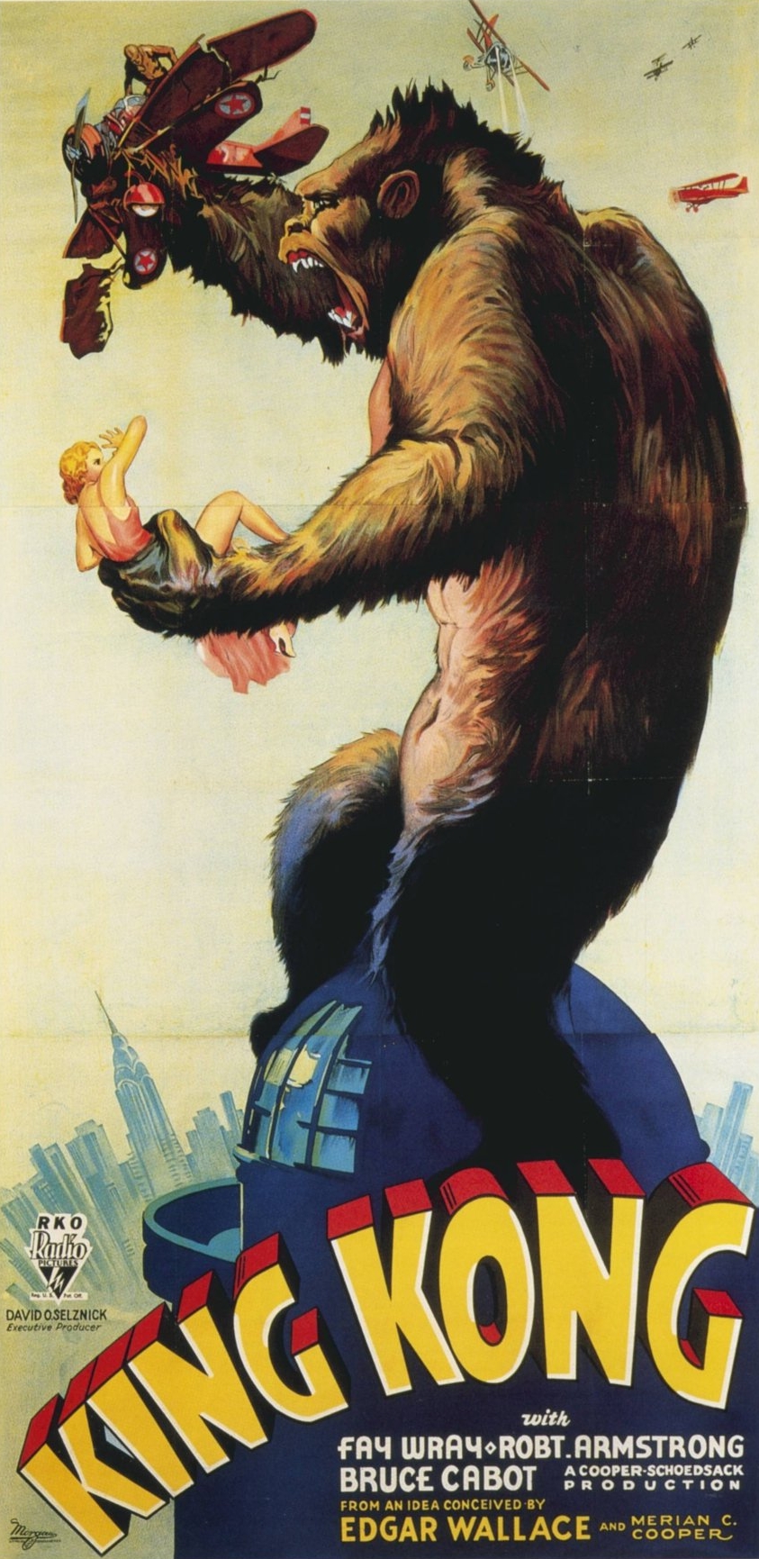 film poster showing the massive King Kong whilst holding the small struggling figure of the woman