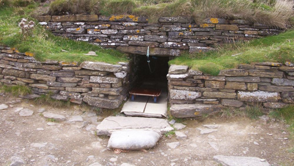 the opening to the Tomb of Eagles Neolithic burial chamber entered by crawling