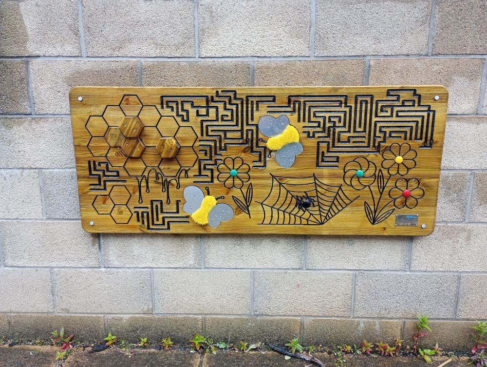 wall art outside Kirkwall Orkney Library with maze and texture for touching