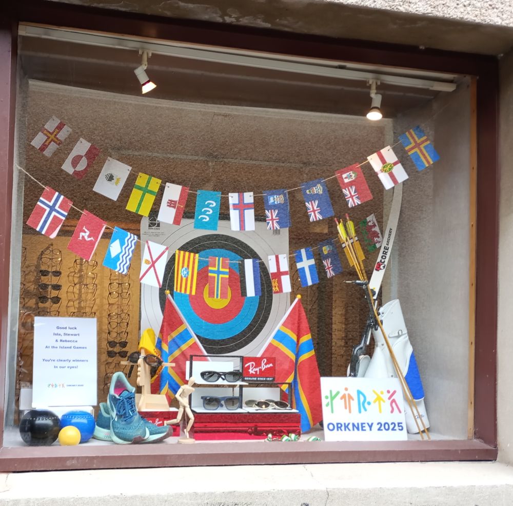 The Opticians window display for the Island Games with the flags of all the countries and other sporting things like goggles