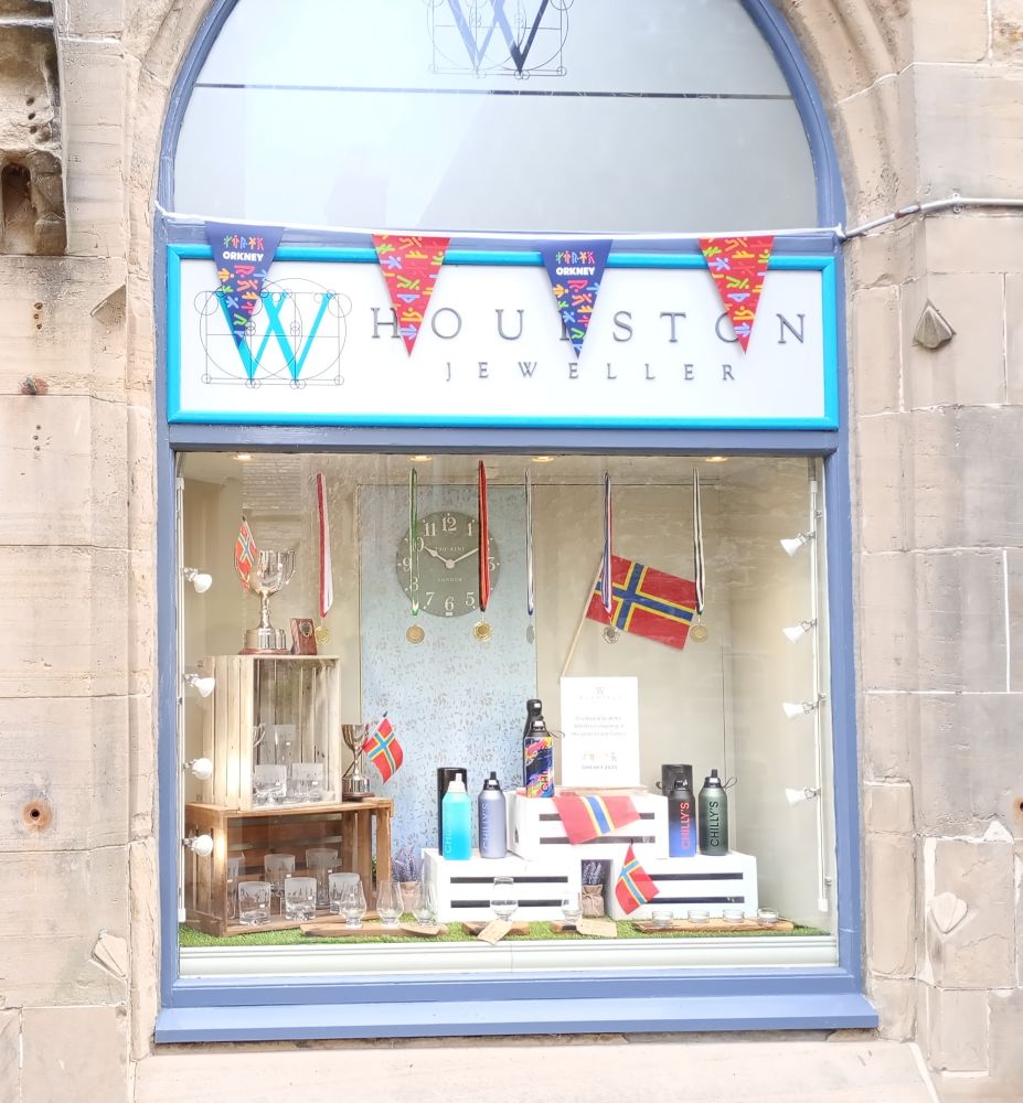 the window display for the Island Games of the Jewellers in Kirkwall with bunting Orkney flags and water bottles
