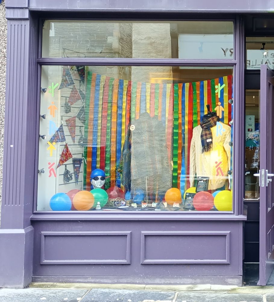 the window display for Aurora and the Island Games with bunting and games items and balloons
