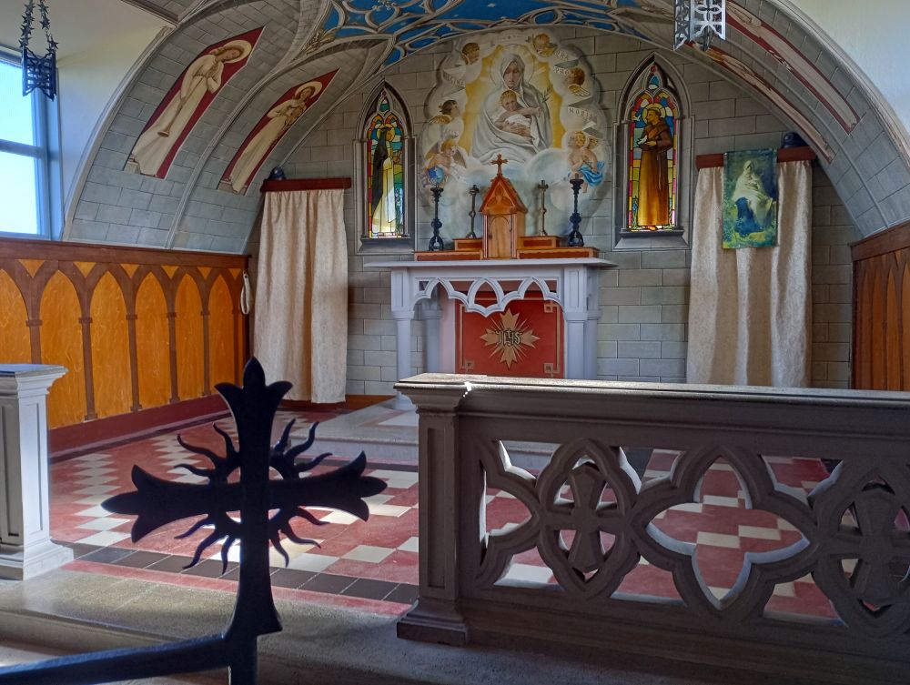 looking towards the altar through the metal work of the screen