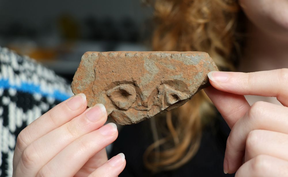 the piece of stone with carvings which may be representative of eyes