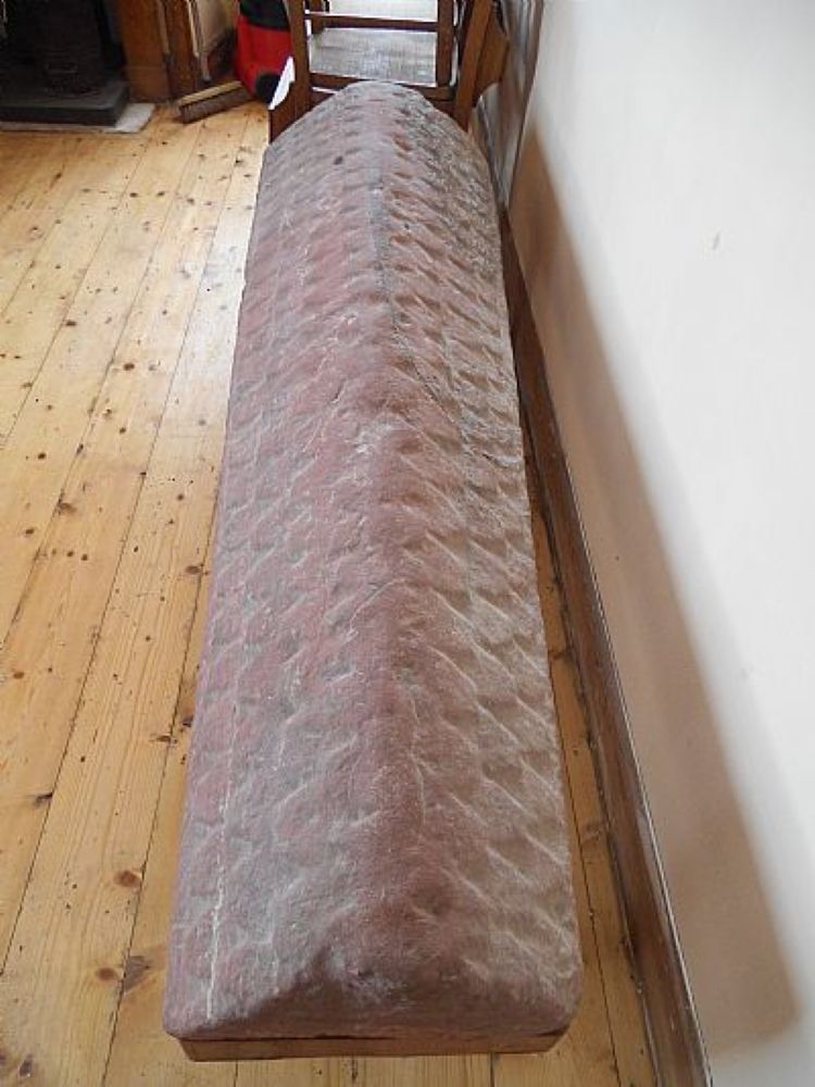 the red sandstone of the Hogsback grave marker with its tiled carved top