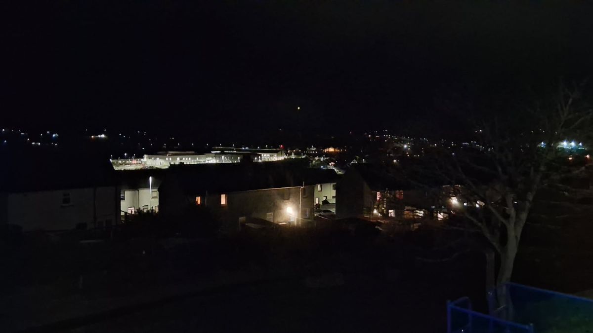 a night scene of Kirkwall looking over the still town and houses and large supermarkets lit up