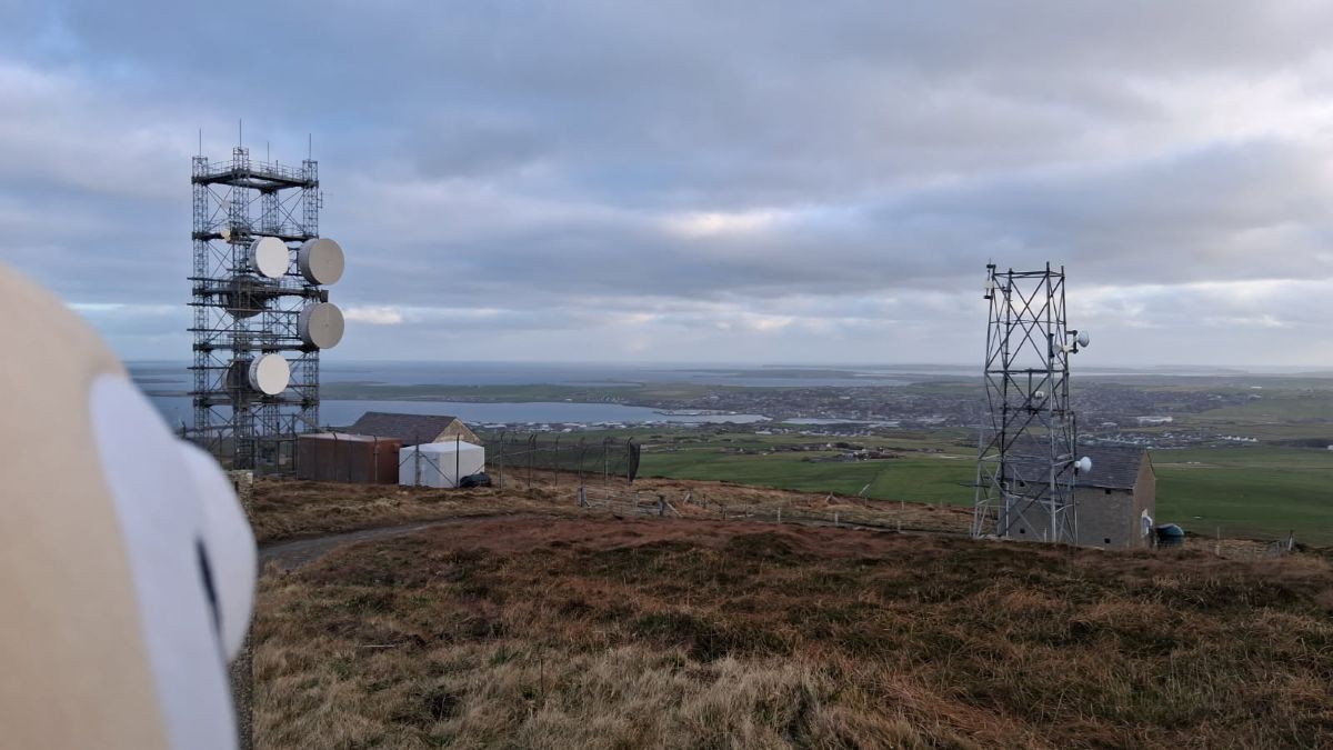 top of Wideford Hill with Rowlet looking over towards Kirkwall with the communication masts