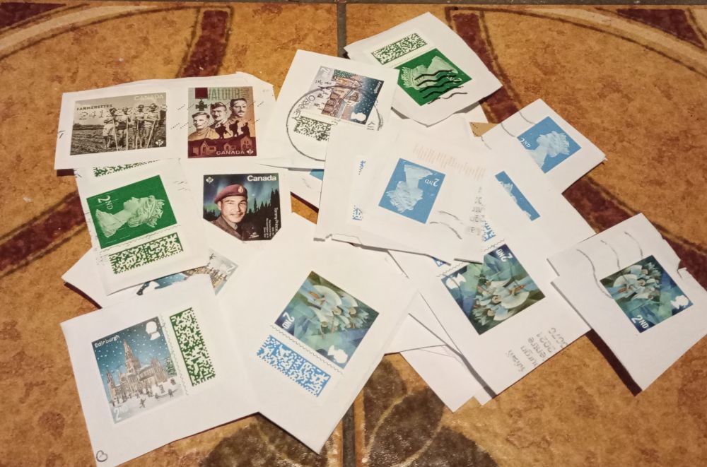 a pile of used postage stamps