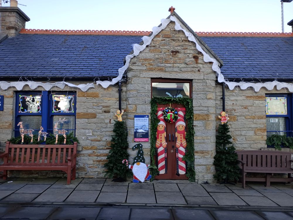 RNLI shop Stromness with Christmas decorations making it look like a little cottage