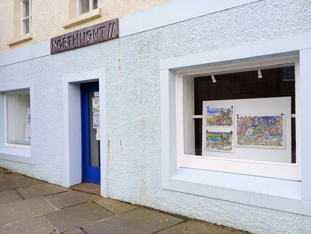 the windows of the Northlight Gallery with Karen Tweeds prints in the window