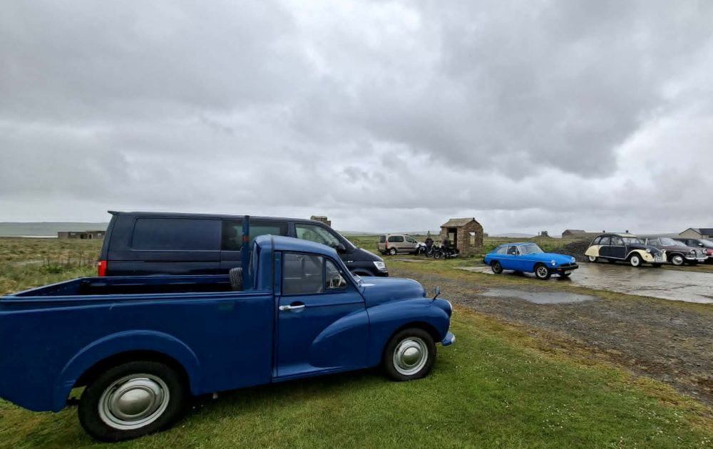 stormy sky as classic cars start to arrive and park up at HMS Tern